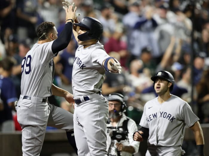 Aug 12, 2021; Dyersville, Iowa, USA; New York Yankees designated hitter Giancarlo Stanton (middle) celebrates with right fielder Aaron Judge (99) after hitting a home run against the Chicago White Sox during the ninth inning at the Field of Dreams.